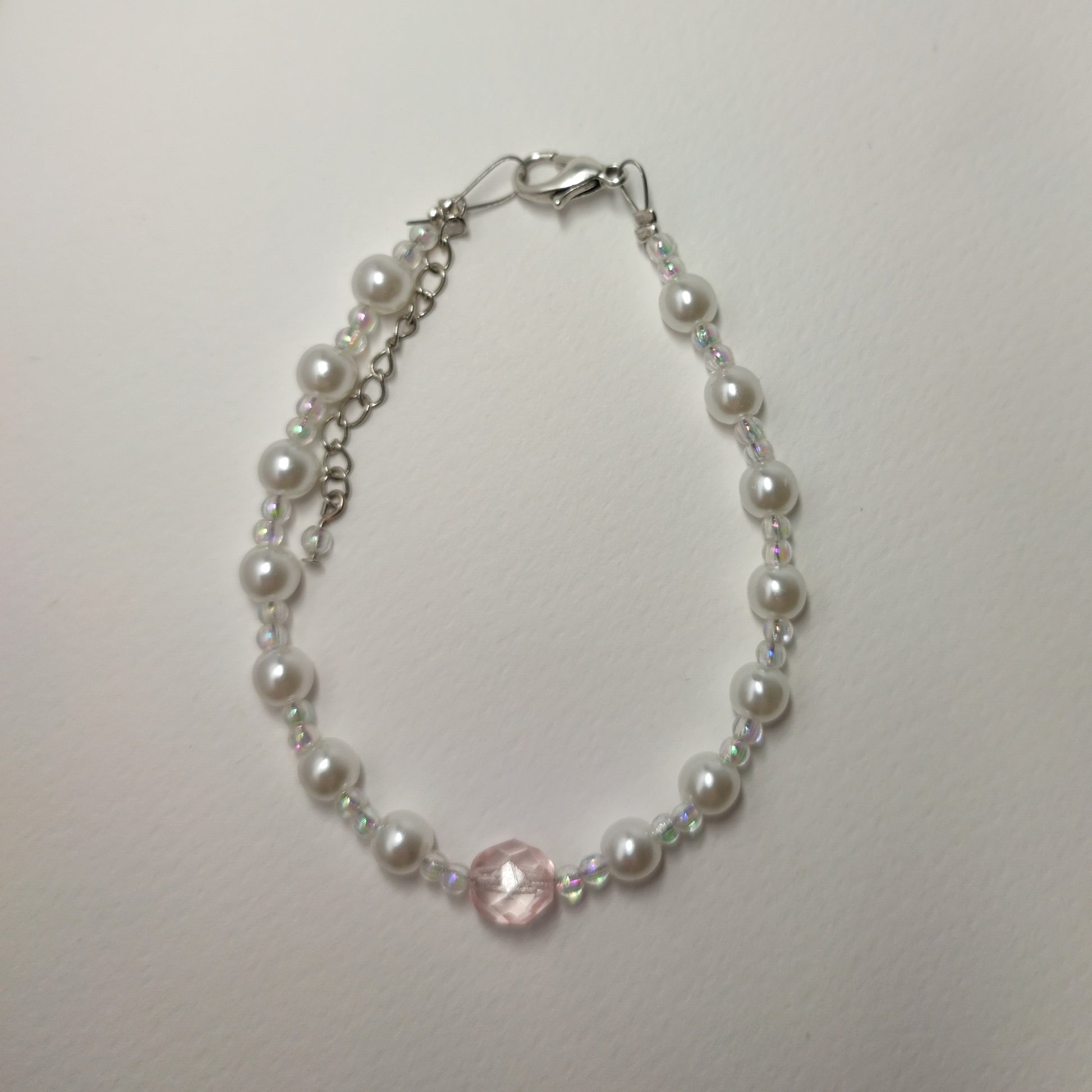 White faux bead bracelet with a series of lustrous faux pearl-like beads
